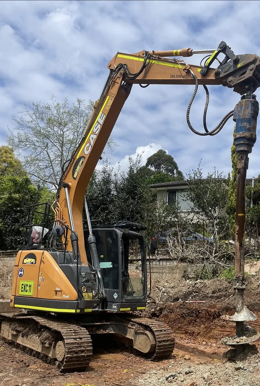 Excavator drilling pier holes at Pymble